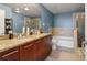 Well-lit bathroom featuring double sinks, a granite countertop, a shower and a separate bathtub at 3324 Peachtree Ne Rd # 814, Atlanta, GA 30326