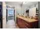 Bathroom featuring a double granite vanity and sinks with views into the bedroom with large windows at 3324 Peachtree Ne Rd # 814, Atlanta, GA 30326