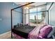 Bright bedroom featuring a four-poster bed, ceiling fan, and balcony with seating overlooking the city at 3324 Peachtree Ne Rd # 814, Atlanta, GA 30326