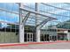 The glass entrance is covered by a metal awning and features red painted curbs at 3324 Peachtree Ne Rd # 814, Atlanta, GA 30326