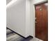 Hallway leading to unit 814 with a wooden door with a brushed metal handle and striped carpet at 3324 Peachtree Ne Rd # 814, Atlanta, GA 30326