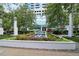 Water feature in the center of a flower garden with manicured beds and sidewalks at 3324 Peachtree Ne Rd # 814, Atlanta, GA 30326