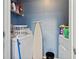 Well-organized laundry area with washer, dryer, shelving, and ironing board for convenient home care at 3324 Peachtree Ne Rd # 814, Atlanta, GA 30326