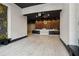 Lobby with a modern reception desk, statement chandelier and tiled floors with moss and bench seating at 3324 Peachtree Ne Rd # 814, Atlanta, GA 30326