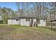 Exterior backyard view of home featuring a spacious lawn and mature trees at 4953 Apple Valley Rd, Douglasville, GA 30135