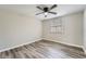 A clean and bright bedroom featuring neutral paint, wood-look floors, and a ceiling fan at 4953 Apple Valley Rd, Douglasville, GA 30135