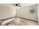 Cozy bedroom featuring wood-look floors, neutral walls, a ceiling fan, and two bright windows at 4953 Apple Valley Rd, Douglasville, GA 30135