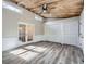 Bonus room with wood paneled ceiling, French doors, and modern flooring at 4953 Apple Valley Rd, Douglasville, GA 30135