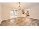 Dining room showcasing new floors, modern light fixture, and view into the kitchen at 4953 Apple Valley Rd, Douglasville, GA 30135