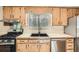 Kitchen showcases light wood cabinets, stainless appliances, neutral countertops, and a garden window at 4953 Apple Valley Rd, Douglasville, GA 30135