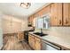 Rustic kitchen featuring wood cabinets, stainless steel appliances, and a large window over the sink at 4953 Apple Valley Rd, Douglasville, GA 30135