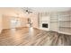 Spacious living room with hardwood floors, fireplace, and views into the kitchen and dining area at 4953 Apple Valley Rd, Douglasville, GA 30135