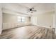 Spacious living area featuring wood-look floors, built-in storage, and a contemporary ceiling fan at 4953 Apple Valley Rd, Douglasville, GA 30135