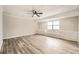 Bright living room with new floors, a ceiling fan, and built-in shelving at 4953 Apple Valley Rd, Douglasville, GA 30135