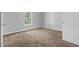 Bright bedroom with a neutral color scheme, plush carpet, and a window at 520 Crick Pt, Palmetto, GA 30268