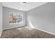 Bright bedroom with plush carpet, large window, and neutral color scheme at 520 Crick Pt, Palmetto, GA 30268