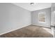 Bedroom featuring tan carpet, light gray walls, white trim, and a window at 520 Crick Pt, Palmetto, GA 30268