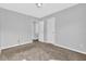 Bedroom featuring tan carpet, light gray walls, white trim, and a ceiling light at 520 Crick Pt, Palmetto, GA 30268