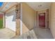 Covered entryway featuring a red front door, brick accents, and a view of the attached garage at 520 Crick Pt, Palmetto, GA 30268