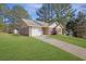View of a single-story home with a well-kept lawn, driveway, and a storage shed on the property at 520 Crick Pt, Palmetto, GA 30268