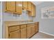 Close-up of a kitchen area showcasing light wood cabinets, a stainless-steel sink, and a neutral countertop at 520 Crick Pt, Palmetto, GA 30268