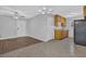 Open kitchen and living area featuring tile floors, wood cabinets, and black refrigerator at 520 Crick Pt, Palmetto, GA 30268