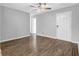 Bright living room with a ceiling fan, wood-look floors, and a white front door at 520 Crick Pt, Palmetto, GA 30268