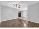 Open-concept living area with wood-look floors flowing into the kitchen featuring tile flooring and black appliances at 520 Crick Pt, Palmetto, GA 30268