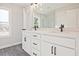 Bathroom vanity with double sinks, black hardware, and a large mirror at 101 Priestwood Ln, Acworth, GA 30102