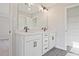 Bathroom featuring double sink vanity, modern hardware, and closet with shelving at 101 Priestwood Ln, Acworth, GA 30102