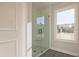 Glass-enclosed shower with a view of the scenic outdoors with a built-in seat for convenience at 101 Priestwood Ln, Acworth, GA 30102