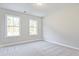 Bright bedroom with light-gray carpet and large windows, offering a cozy atmosphere at 101 Priestwood Ln, Acworth, GA 30102