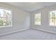Bright bedroom featuring neutral paint and carpet, and natural light through a large window at 101 Priestwood Ln, Acworth, GA 30102
