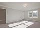 Spacious bedroom with carpeted flooring, neutral walls, and plenty of natural light from the large window at 101 Priestwood Ln, Acworth, GA 30102