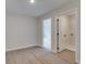 Bedroom showcasing wood floors, neutral walls, and an open door to the laundry room at 101 Priestwood Ln, Acworth, GA 30102