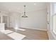 Dining area features an elegant light fixture, luxury vinyl flooring, and neutral paint at 101 Priestwood Ln, Acworth, GA 30102