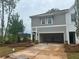 A beautifully designed two-story townhome with a two-car garage and manicured lawn at 101 Priestwood Ln, Acworth, GA 30102