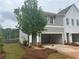 Side view of a new construction townhome with an attached two-car garage and landscaped yard at 101 Priestwood Ln, Acworth, GA 30102