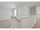 Bright hallway with hardwood floors, white walls, and stairway at 101 Priestwood Ln, Acworth, GA 30102
