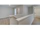 Bright hallway featuring light wood floors and white walls leading to doorways at 101 Priestwood Ln, Acworth, GA 30102