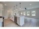 Spacious kitchen with white cabinets, stainless appliances, and a large center island at 101 Priestwood Ln, Acworth, GA 30102