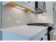 Modern kitchen counter with stainless steel appliances, tile backsplash, and sleek hardware at 101 Priestwood Ln, Acworth, GA 30102
