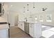 Modern kitchen features white cabinetry, stainless steel appliances, and an island with pendant lighting at 101 Priestwood Ln, Acworth, GA 30102