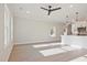 Bright living room area with a ceiling fan and recessed lighting flowing into the modern kitchen at 101 Priestwood Ln, Acworth, GA 30102