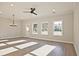 Spacious living room filled with natural light, hardwood floors, and a modern ceiling fan at 101 Priestwood Ln, Acworth, GA 30102