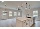 Spacious living room with kitchen island, modern lighting, and convenient back door at 101 Priestwood Ln, Acworth, GA 30102