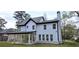 Back exterior of home featuring a patio, many windows, and a grassy lawn at 355 Hilltop Cir Sw Ext, Mableton, GA 30126