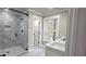 Modern bathroom featuring a glass shower with black hardware, a window, and a white vanity at 355 Hilltop Cir Sw Ext, Mableton, GA 30126