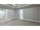 Spacious bedroom with tray ceiling, neutral walls, carpet, and Primary bathroom at 355 Hilltop Cir Sw Ext, Mableton, GA 30126