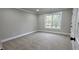 Neutral carpeted bedroom with base molding and a window providing natural light at 355 Hilltop Cir Sw Ext, Mableton, GA 30126